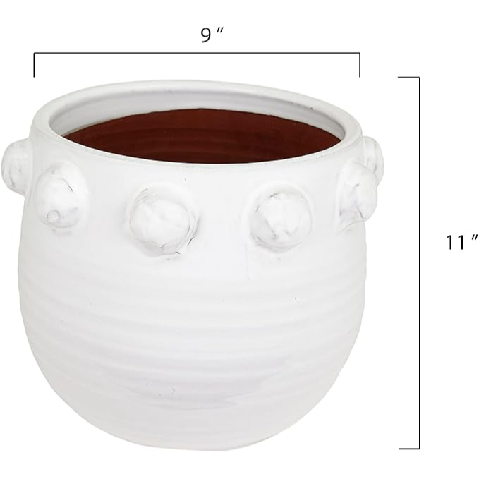 White ceramic planter with decorative knobs on a white background